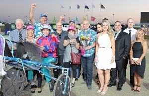 Tact Tate trainer/driver Amanda Turnbull with elated winning owners after taking out the 4YO Bonanza. 