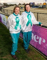 Jodi Quinlan and Kerryn Manning wearing the teal silks and driving pants last year.