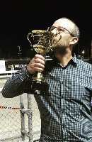Part-owner Matt McLellan kisses the Mildura Pacing Cup after his star Hectorjayjay won the race on Saturday night. 
