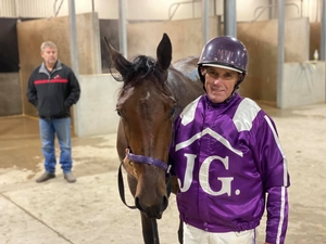 Trainer-driver Mark Hewitt pictured with unbeaten filly Not To Be Denied.