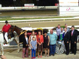 Beam me up: Connections of Ideal Scott celebrate their victory in the Garrards Queensland Pacing Championship at Albion Park