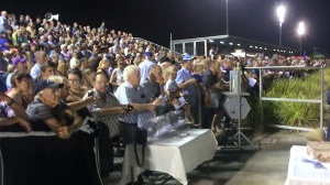 A big crowd watches on at the Shepparton trots. 