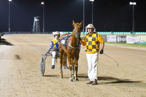 Grant Forrest standing with Orlando Storm after a victory at Tabcorp Park Menangle on Saturday night.